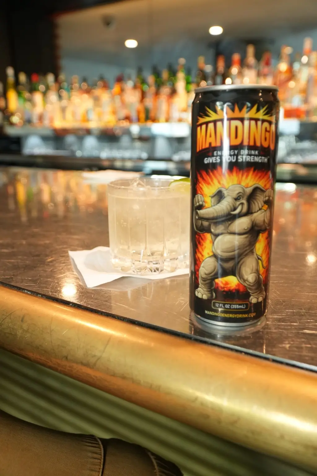 Mandingo Original can served beside a drink at a bar