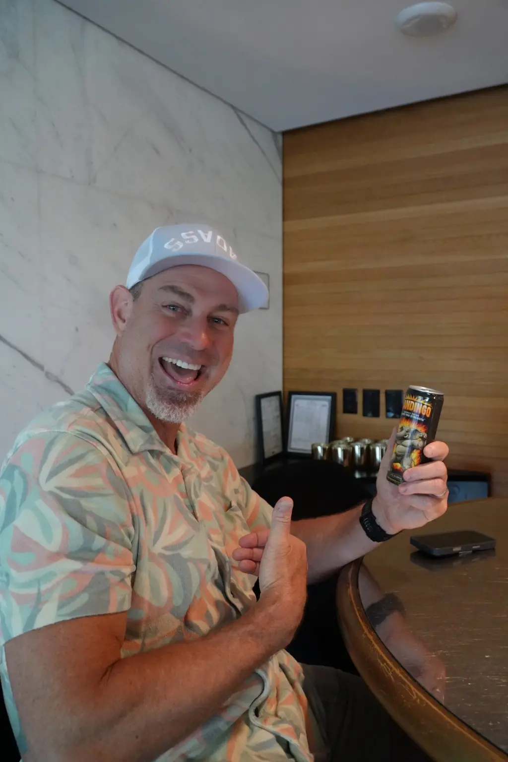 Mandingo customer smiling and holding an Original can