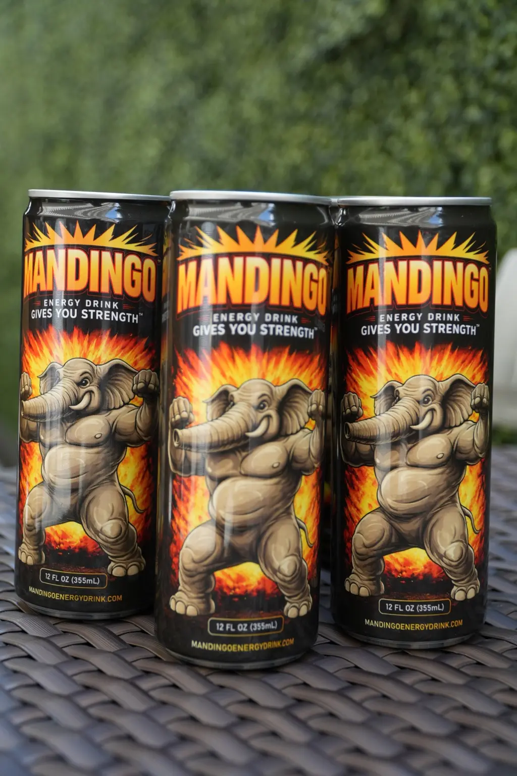 Three cans of Mandingo Original displayed outdoors